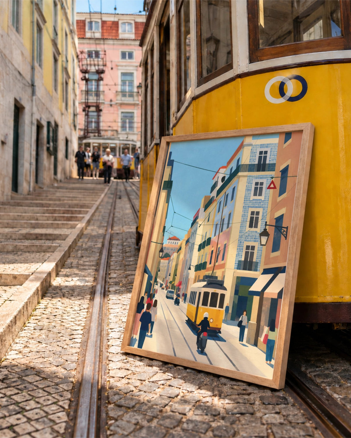 Lisbon in Motion art print in a natural wood frame leaning beside a yellow tram on a cobbled Lisbon street.