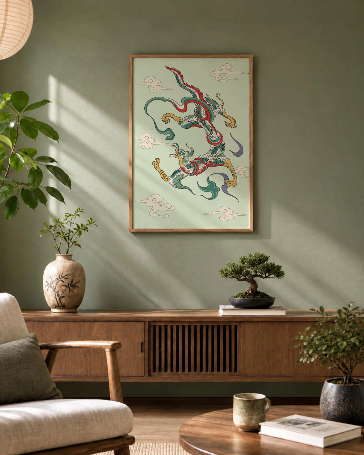 Dragon Dance art print framed in natural wood above a sideboard in a sunlit living room with green walls and Japanese-inspired decor.