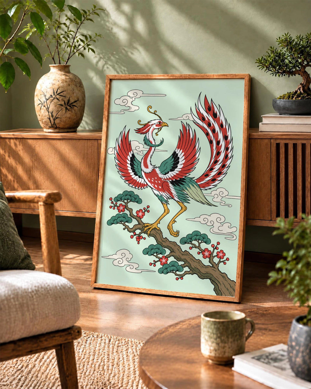 Affiche Phoenix Bloom en cadre en bois naturel posée contre un buffet en bois, avec un phénix perché sur une branche en fleurs