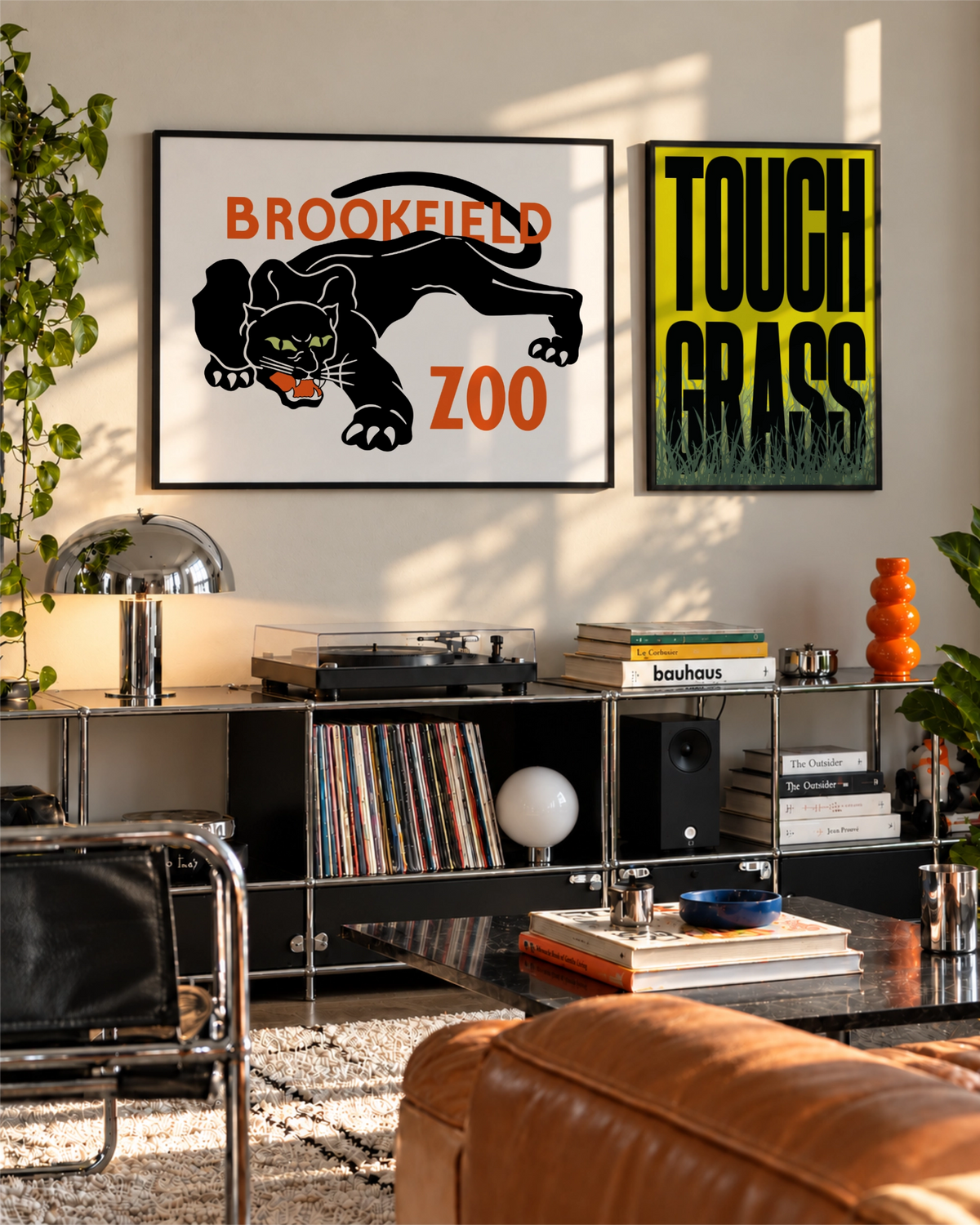 Night Prowl art print displayed beside Touch Grass above a black modular media unit in a sunlit contemporary living room.