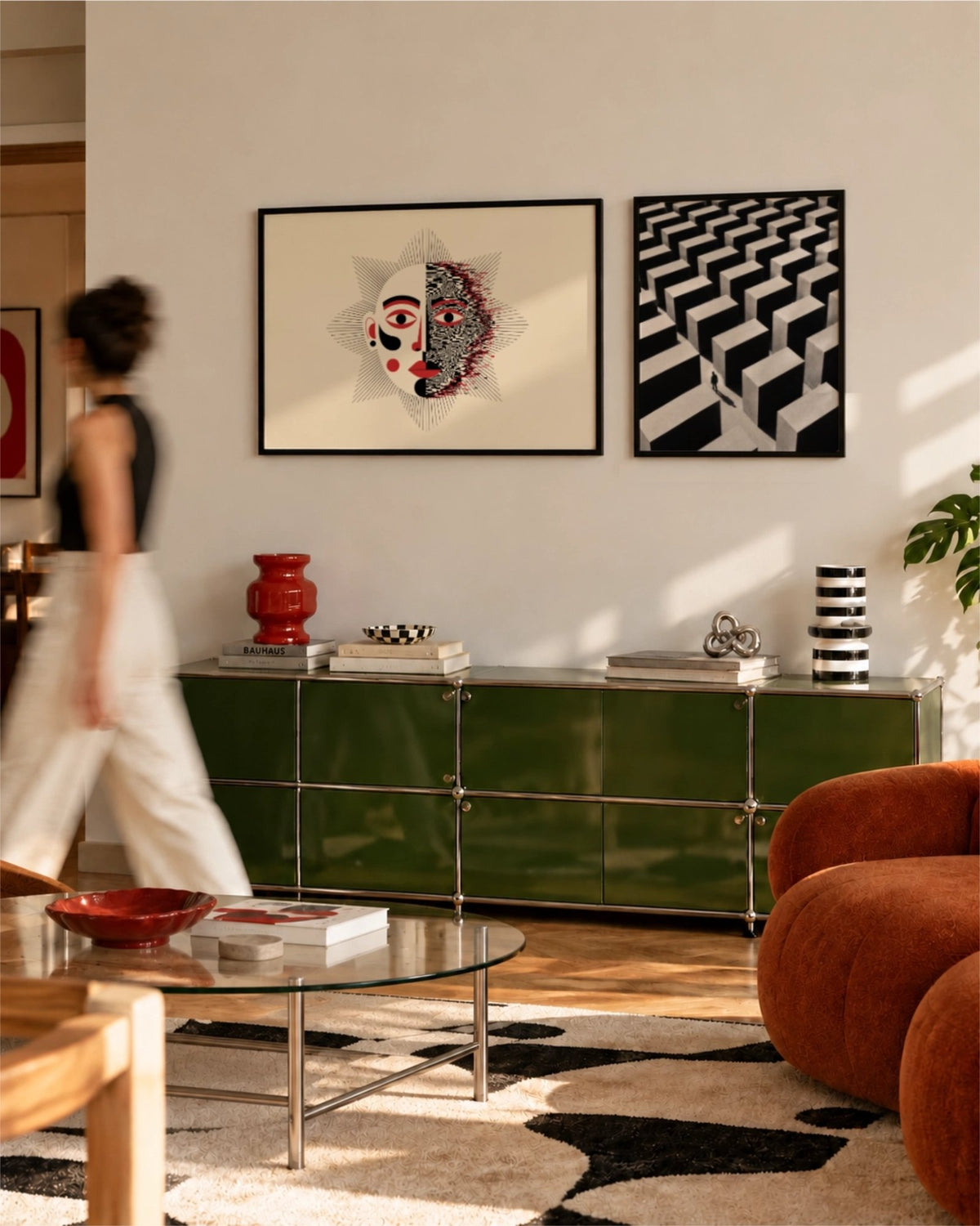 Duality displayed in a black frame beside Lost in the Grid, a black-and-white geometric print, above a green sideboard in a contemporary living room