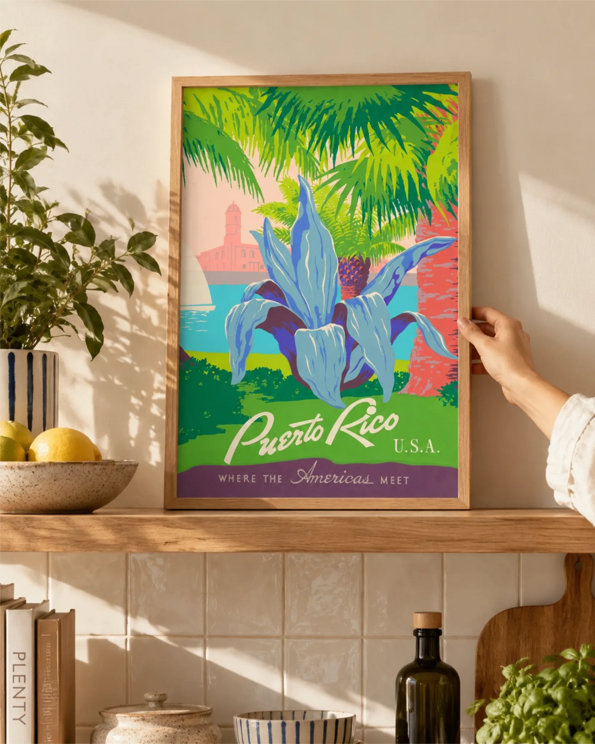 Discover Puerto Rico vintage travel poster in a natural wood frame styled on a kitchen shelf with plants and ceramics.